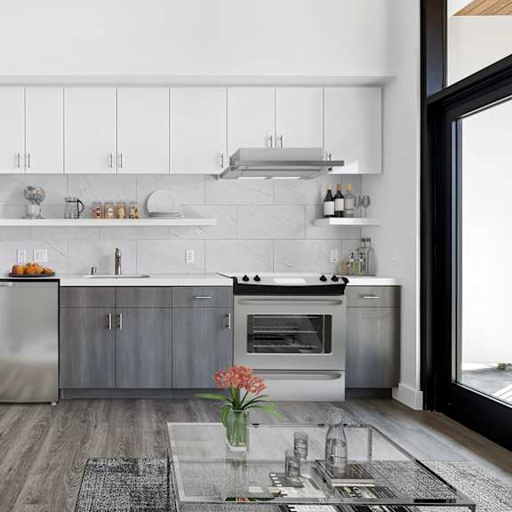 A modern kitchen with a stainless steel refrigerator, oven, and cabinets.