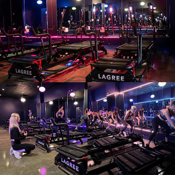 A gym with people exercising and treadmills with the brand name "LAGREE" on them.