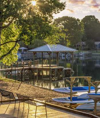 a dock with boats and a gazebo on the water