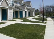 Thumbnail 3 of 4 - a row of houses with blue doors and white siding