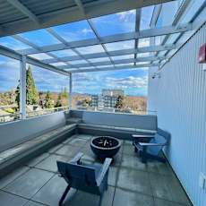 A patio with a table and chairs overlooking a scenic view at Nomad Apartments, Oregon