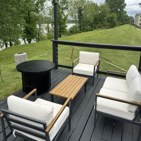 a patio with a table and chairs and a fire pit at Brightwaters Apartments, Little Rock, Arkansas