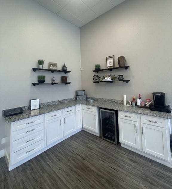 a kitchen with white cabinets and a counter top at Whispering Oaks in  Conroe, TX