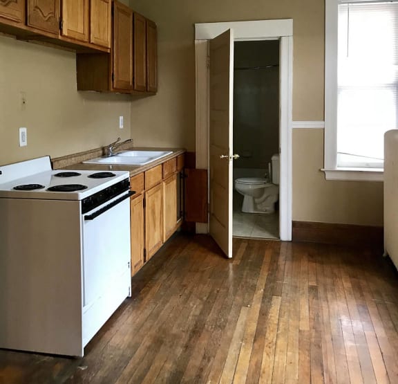 a kitchen with a wooden table and a stove and refrigerator