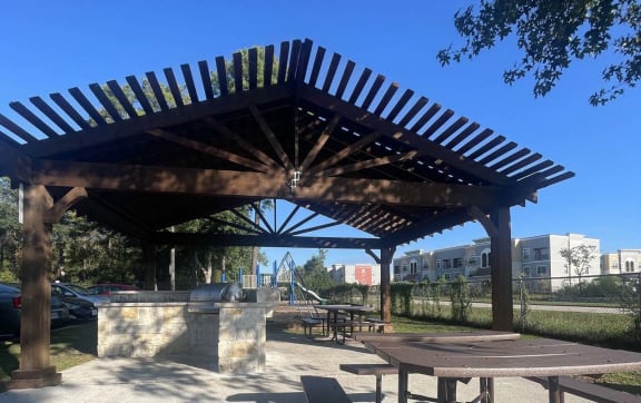 a picnic area with a picnic table and a pavilion at Whispering Oaks in  Conroe, TX