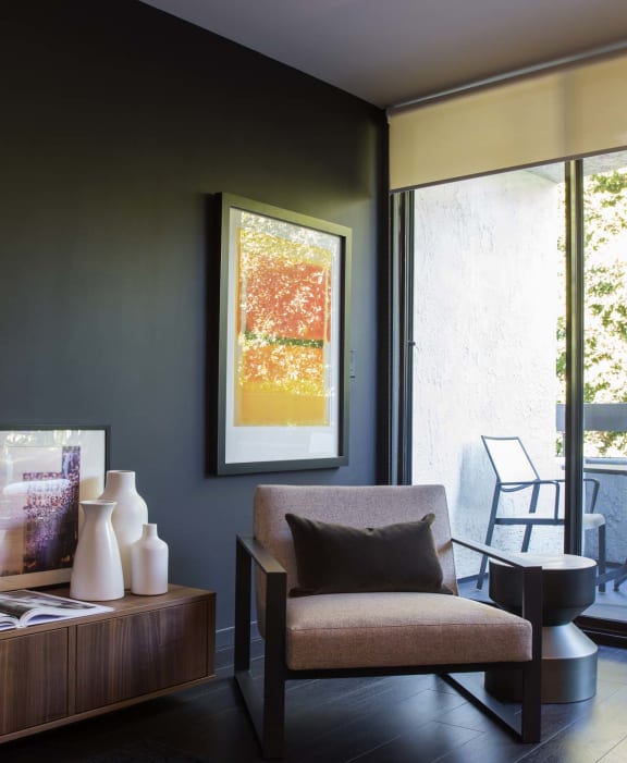 a chair and ottoman in the living room  at 888 Hilgard – Furnished Apartments, Los Angeles, CA