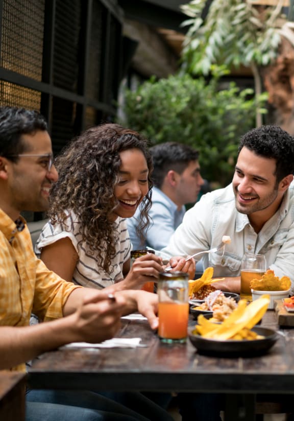 a group of people sitting around a table eating food