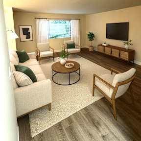A living room with a white couch, a coffee table, and a television.