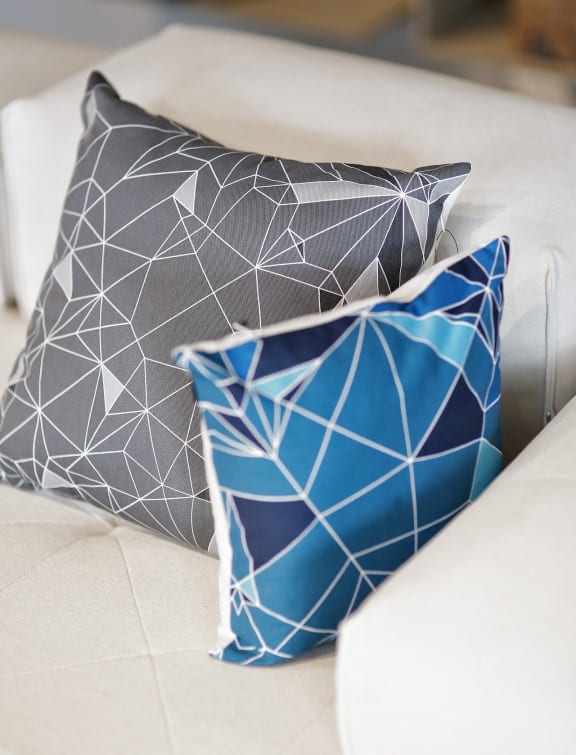 a group of pillows sitting on top of a couch