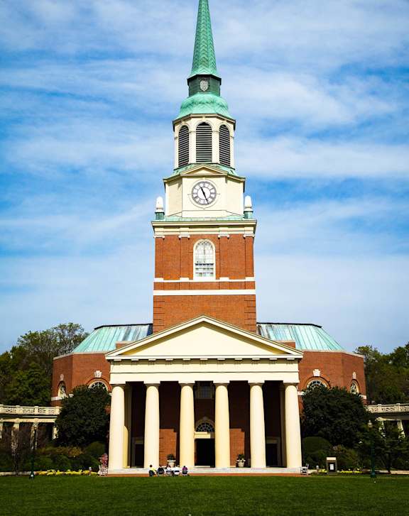 A church with a green steeple and a clock tower at West Oak Apartments, Wake Forest, NC 27587