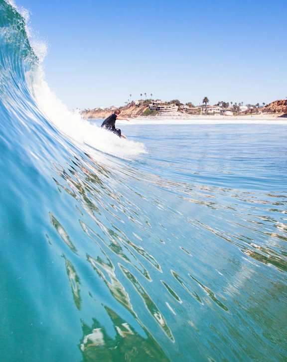 A surfer riding a wave in the ocean.at Pacific Bay Club Apartments, San Diego