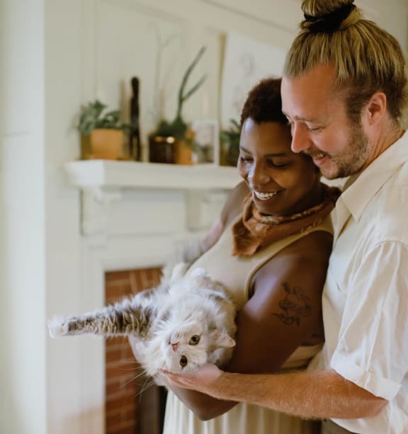 a bride and groom hold their dog