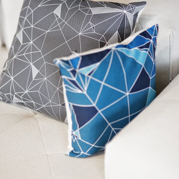 a group of pillows sitting on top of a couch