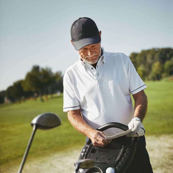 Man is holding a golf club at Hadley Apartments, California, 92026