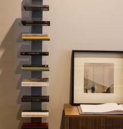 a shelf of books in a room with a picture and a cabinet  at 888 Hilgard – Furnished Apartments, Los Angeles, CA