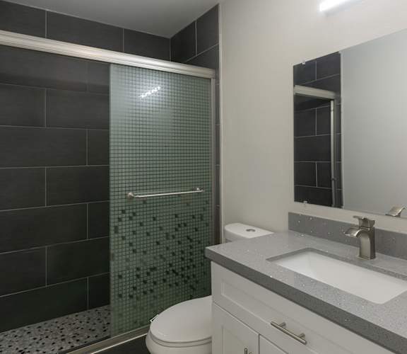 a bathroom with a toilet sink and shower