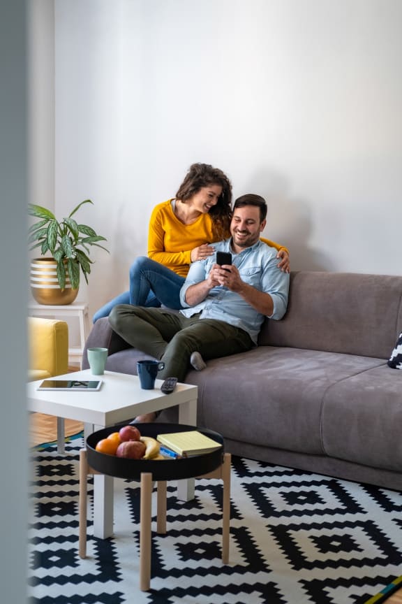 Couple Sitting on Couch Together Smiling