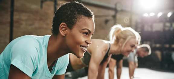 A group of people are exercising in a gym.