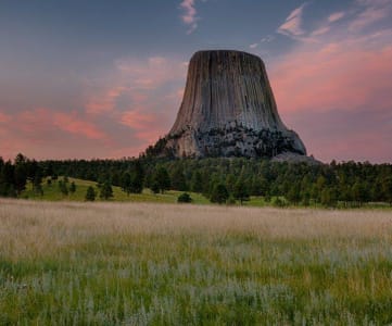 a view of devils tower at sunset