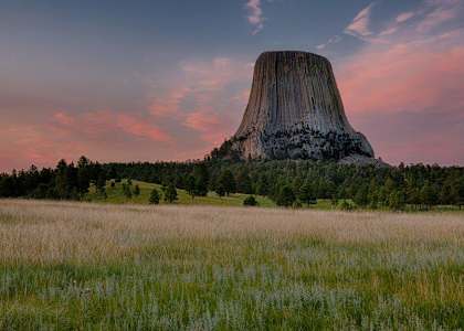 a view of devils tower at sunset