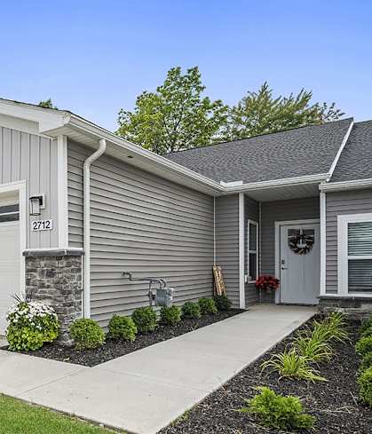 a white house with a driveway and a garage door