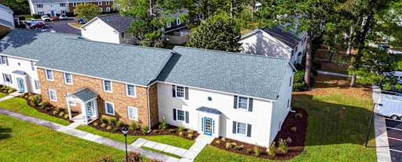 A bird's eye view of a residential area with houses and trees.
