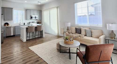 a living room and kitchen with a couch and a table at Zora Encanto, Arizona 85035