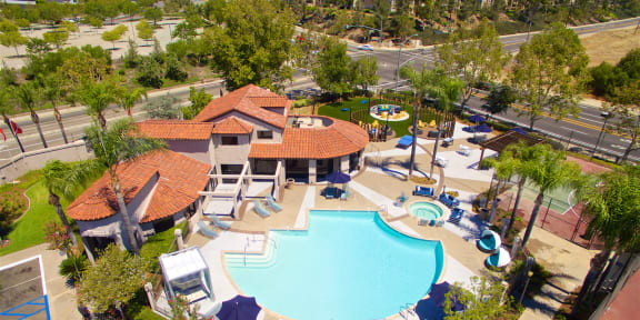 an aerial view of a swimming pool with a pool house and other amenities at Vista Promenade Apartments, Temecula, 92591