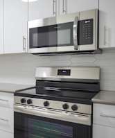 A modern kitchen with a stainless steel dishwasher and oven.