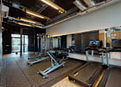 Thumbnail 6 of 8 - A gym with treadmills and other exercise equipment.