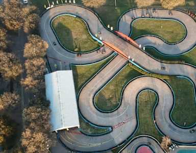 A winding road with a red line in the middle and a white line on the side.