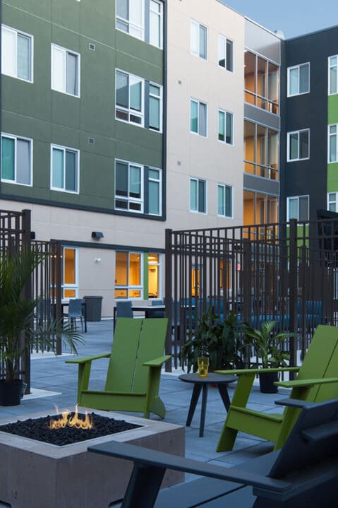 an outdoor patio with chairs and a fire pit