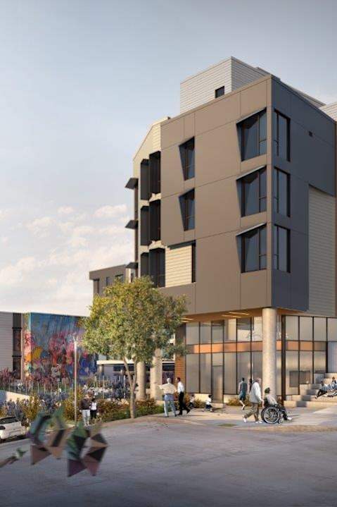 A modern apartment complex with people walking around outside.