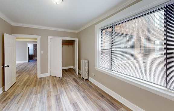 A room with a window and a radiator on the wall.