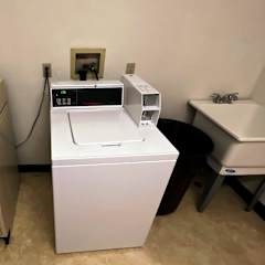 a washer and dryer are next to a sink
