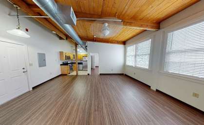 A room with wooden floors and a white door.