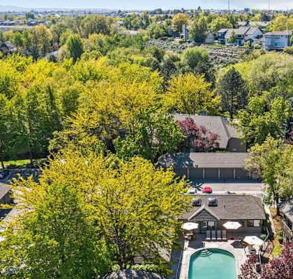 A bird's eye view of a residential area with houses and trees.