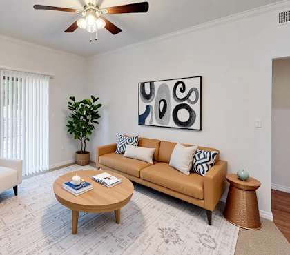 A living room with a couch, chair, and coffee table.