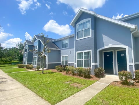 Apartment building exterior surrounded by native landscaping