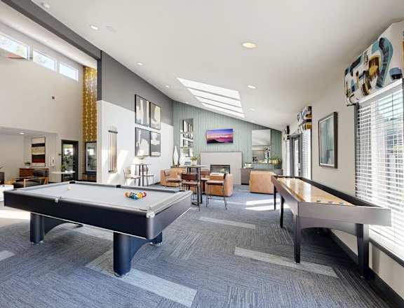 A spacious room with a pool table and comfortable seating.