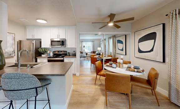 A modern kitchen with a dining table and chairs.