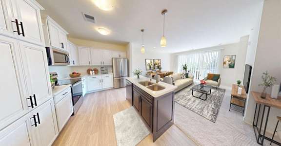 an open kitchen and living room with a couch and a table