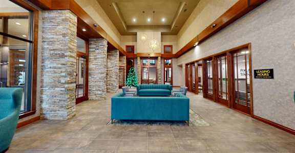 A reception area with a blue table and a stone pillar.