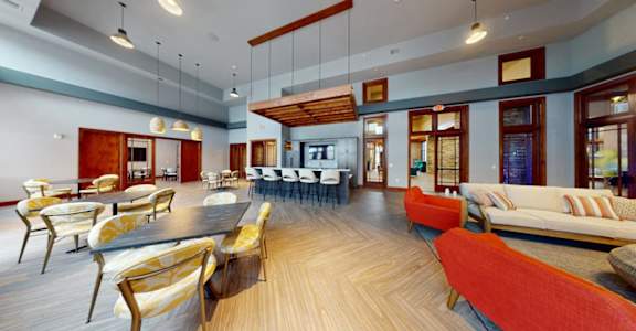 A modern living room with a long wooden table and chairs.