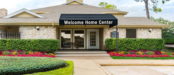 the entrance to the welcome home center in a brick building