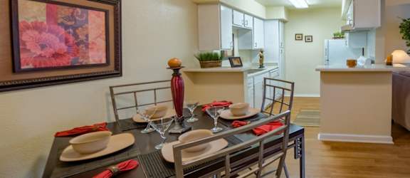 a dining room with a table and chairs and a kitchen