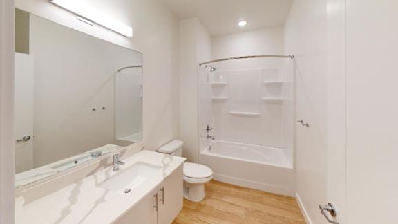 A white bathroom with a walk in shower.