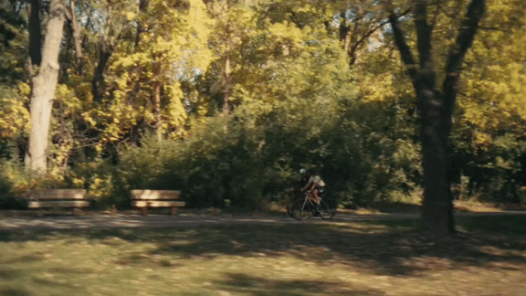 A person riding a bicycle in a park.