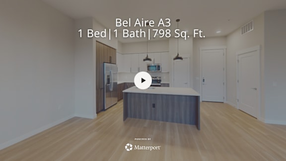 A bedroom with a bed and a bath in a Bel Air apartment.