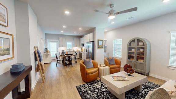 A spacious kitchen with a refrigerator, sink, and cabinets.